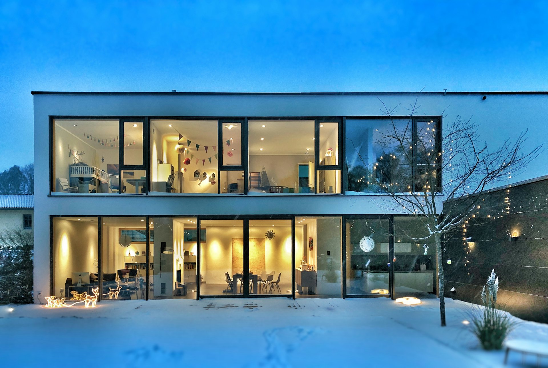 A welcoming family home with warm lit windows at dusk